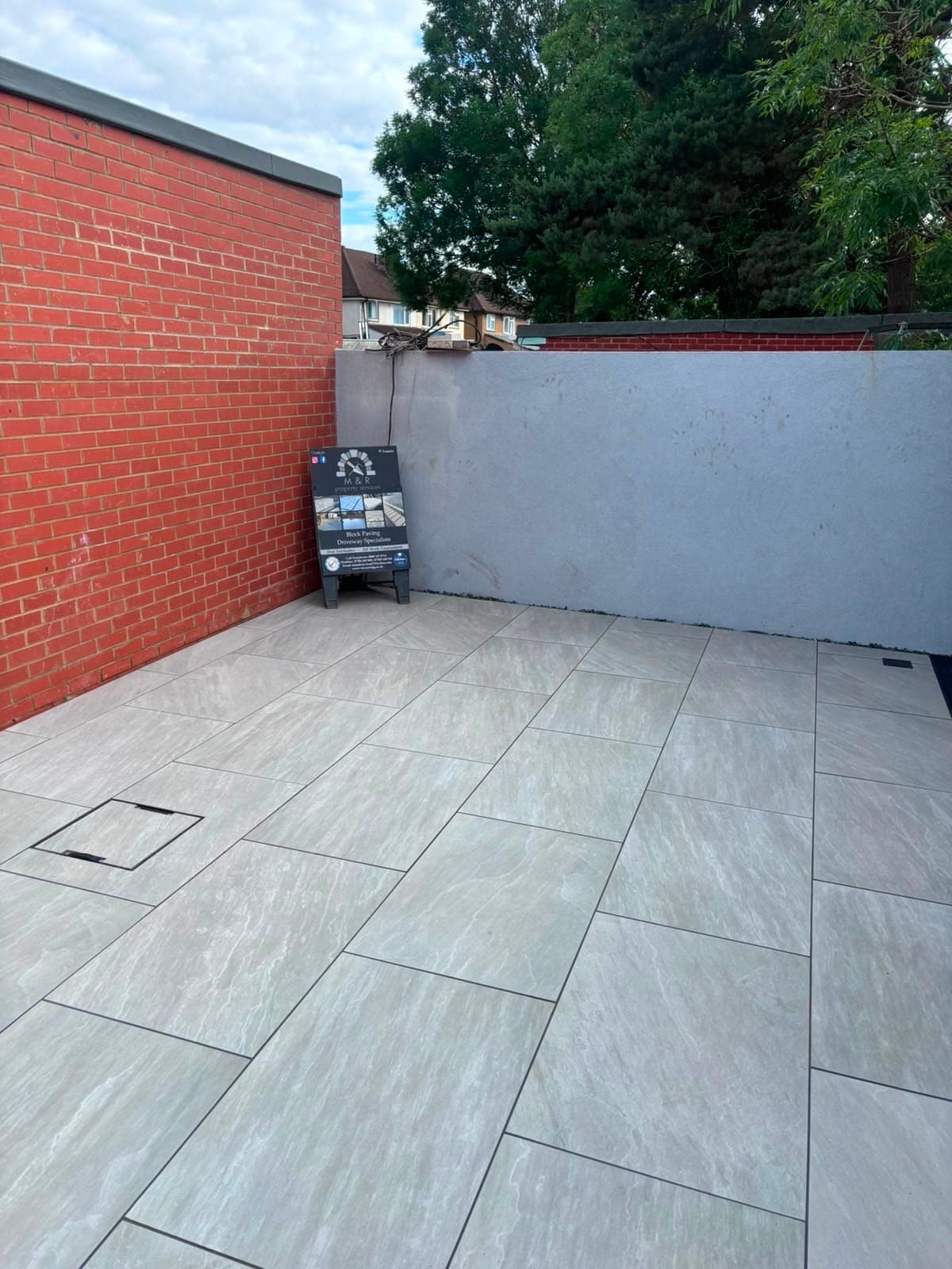 Porcelain paved garden patio laid by M&R Property & Paving Services
