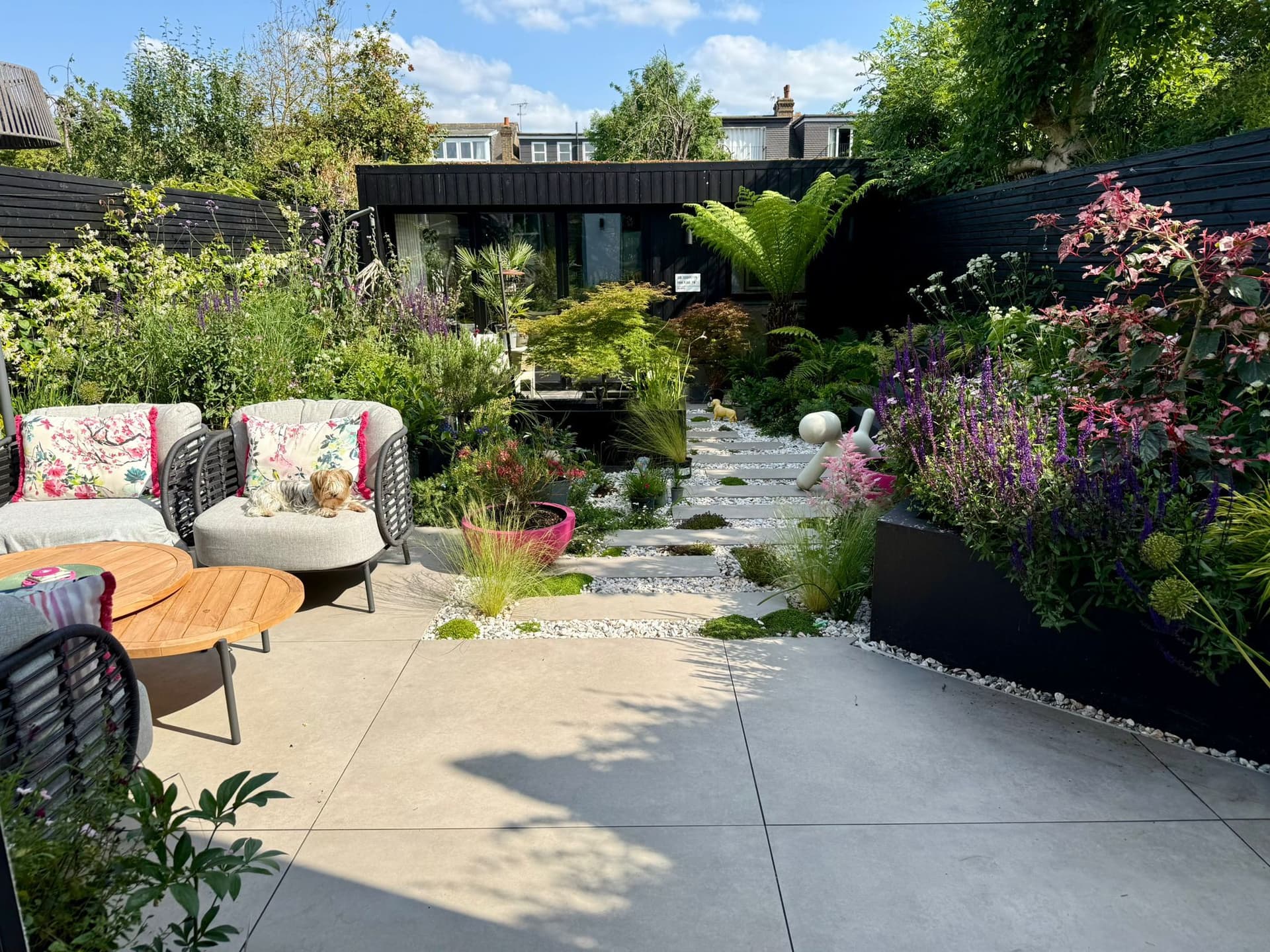 Landscaped garden by M&R Property & Paving Services with porcelain paving, stepping slabs and planted borders