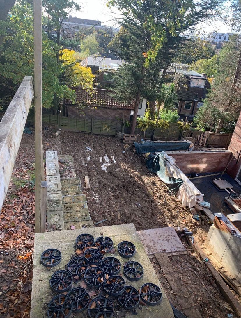 Sloping site with retaining walls under construction by M&R Property & Paving Services before paving is laid